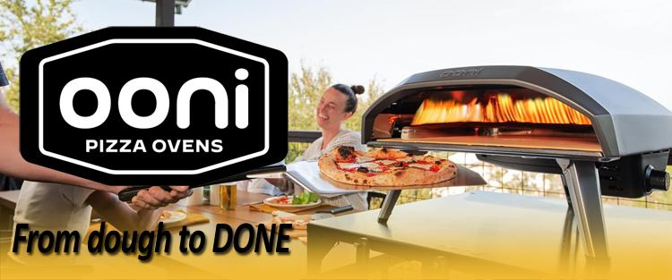 Ooni pizza oven with a person holding a pizza, outdoor setting